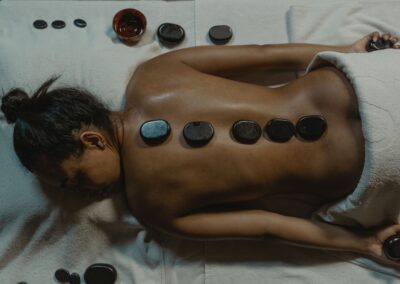 A serene spa scene with hot stone massage therapy focusing on health and relaxation.