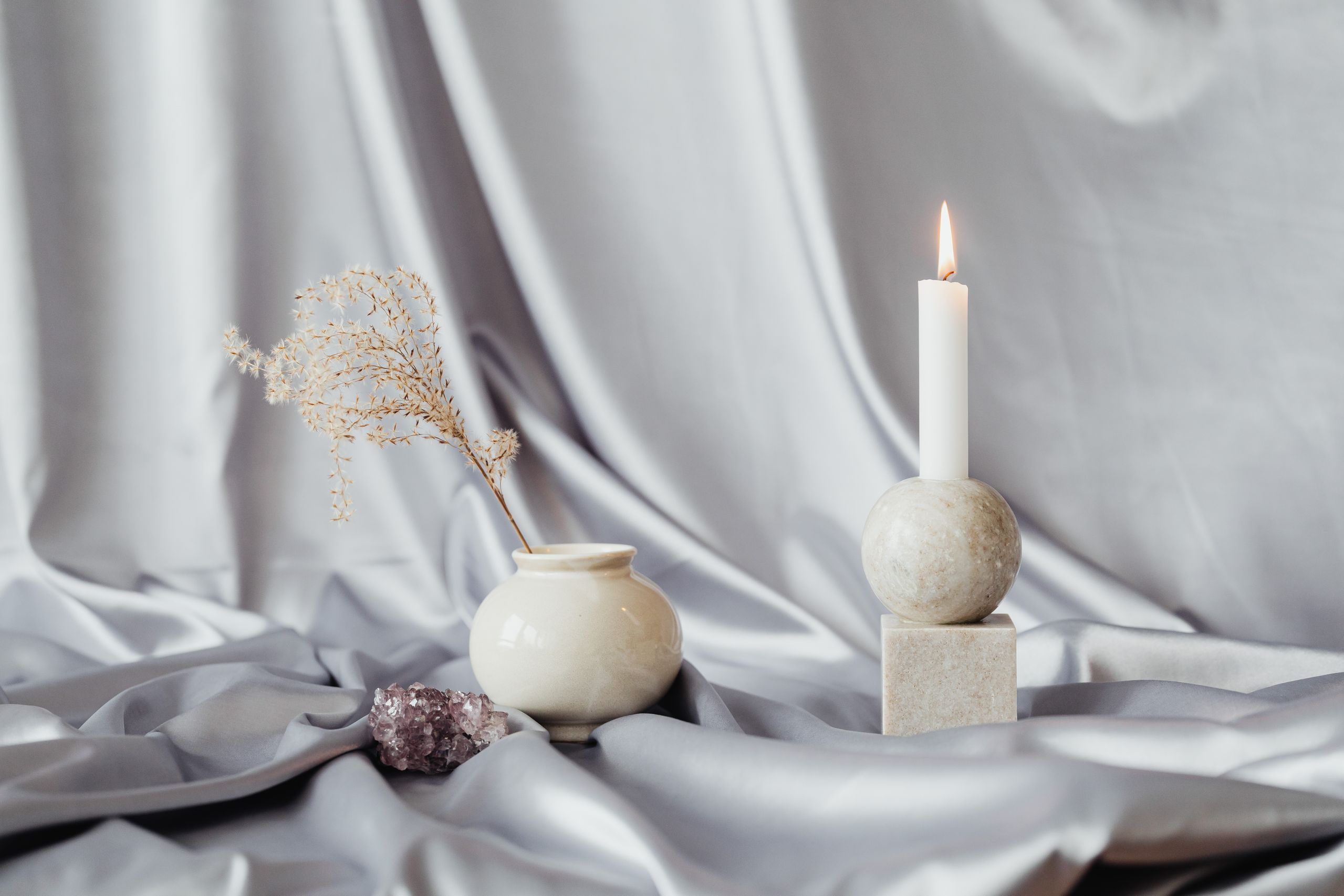 Vase with stones and candle