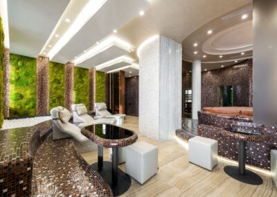 Comfortable heated tiled chaise lounges and bathtubs in modern luxurious spa center decorated with creative illumination and fresh green plants on walls